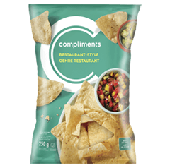 Green package of Compliments Restaurant Style Tortilla Chips