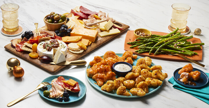 Plates of charcuterie, appetrizers, and asparagus.