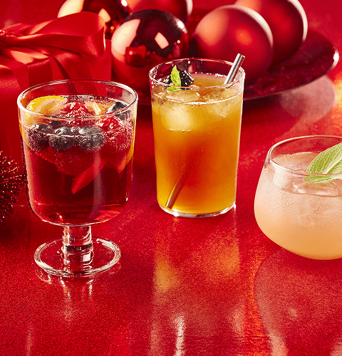 Sparkling sangria, festive iced tea and wintery citrus spritz on a red background.
